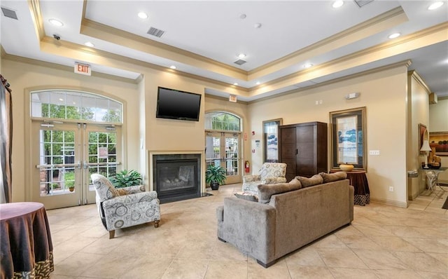 5 Case Ct, Monroe, NY 10950 - living area featuring a raised ceiling, ornamental molding, french doors, light tile patterned flooring, and a fireplace with flush hearth