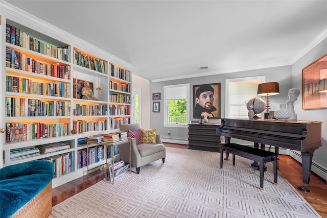5 Gabriels Dr, Chester, NY 10918 - sitting room featuring a baseboard heating unit, ornamental molding, wood finished floors, wall of books, and baseboards