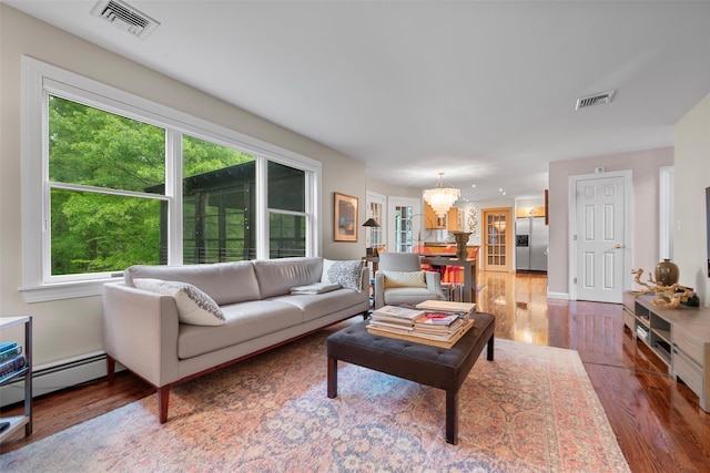 5 Gabriels Dr, Chester, NY 10918 - living area with a chandelier, wood finished floors, plenty of natural light, and baseboard heating