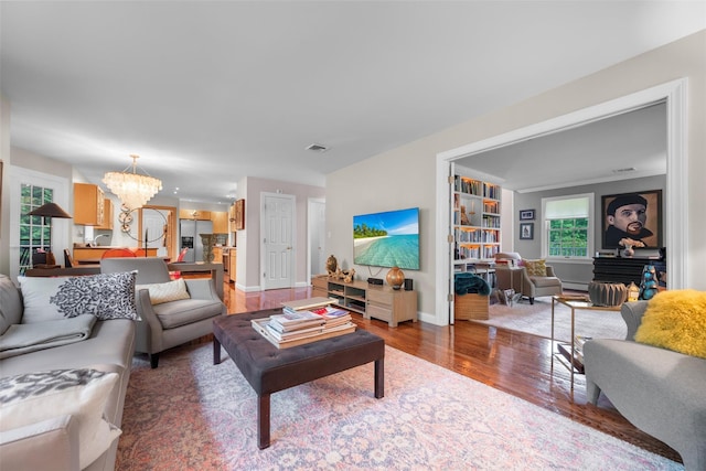 5 Gabriels Dr, Chester, NY 10918 - living area with a chandelier, wood finished floors, baseboards, and baseboard heating