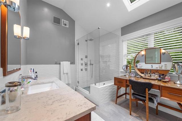 5 Gabriels Dr, Chester, NY 10918 - bathroom featuring a stall shower, vaulted ceiling, vanity, a skylight, and tile patterned flooring