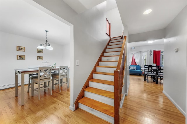 3 Sebastian Ct, Hopewell Junction, NY 12533 - stairway with wood finished floors, baseboards, and a chandelier