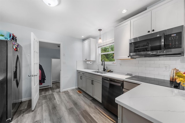 3 Sebastian Ct, Hopewell Junction, NY 12533 - kitchen featuring stainless steel appliances, a sink, light stone countertops, backsplash, and light wood-type flooring