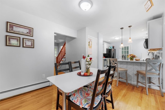 3 Sebastian Ct, Hopewell Junction, NY 12533 - dining space featuring light wood-type flooring, a baseboard radiator, and stairs