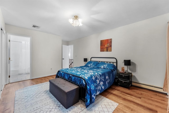 3 Sebastian Ct, Hopewell Junction, NY 12533 - bedroom featuring a baseboard radiator, wood finished floors, a chandelier, and connected bathroom