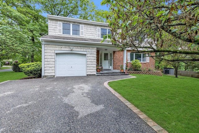 16 Gray Ave, Dix Hills, NY 11746 - view of front of house with a front lawn, an attached garage, and asphalt driveway