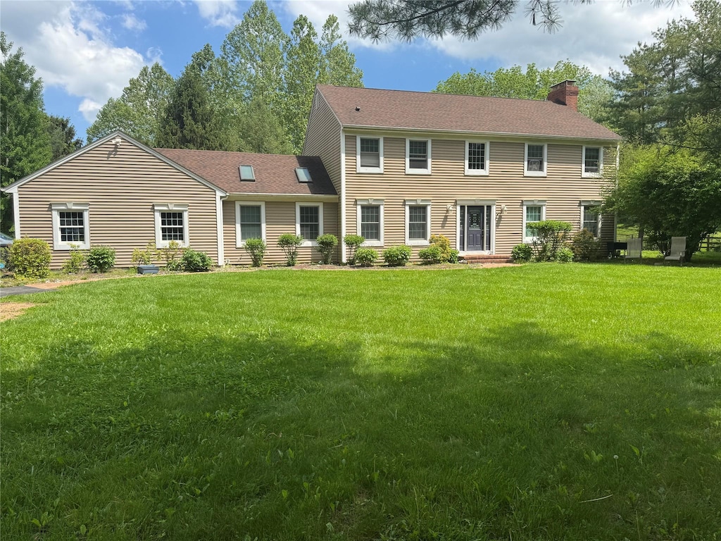 150 Cedar Ave, Poughkeepsie, NY 12603 - colonial house featuring a chimney and a front yard
