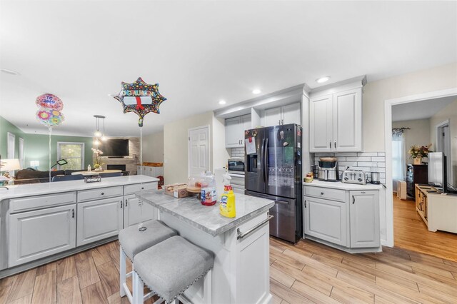 150 Cedar Ave, Poughkeepsie, NY 12603 - kitchen with stainless steel appliances, light countertops, open floor plan, decorative backsplash, and a center island