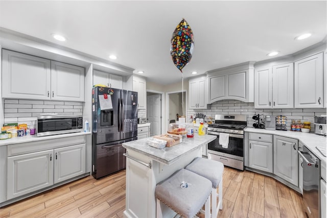 150 Cedar Ave, Poughkeepsie, NY 12603 - kitchen with appliances with stainless steel finishes, light countertops, tasteful backsplash, light wood-style flooring, and recessed lighting
