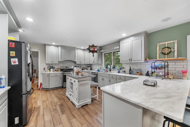 150 Cedar Ave, Poughkeepsie, NY 12603 - kitchen with stainless steel appliances, a sink, a peninsula, decorative backsplash, and recessed lighting