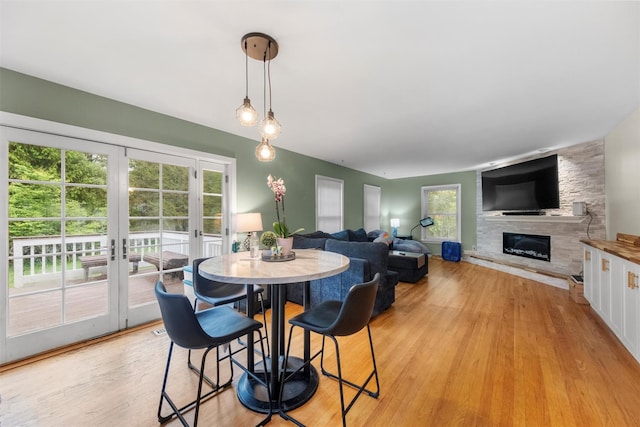 150 Cedar Ave, Poughkeepsie, NY 12603 - dining room featuring french doors, a stone fireplace, and light wood finished floors