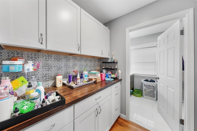 150 Cedar Ave, Poughkeepsie, NY 12603 - kitchen with wood counters, white cabinets, and tasteful backsplash