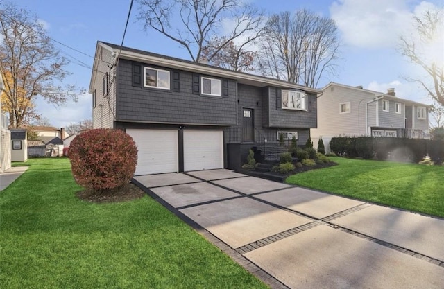 split foyer home with a garage, concrete driveway, and a front yard