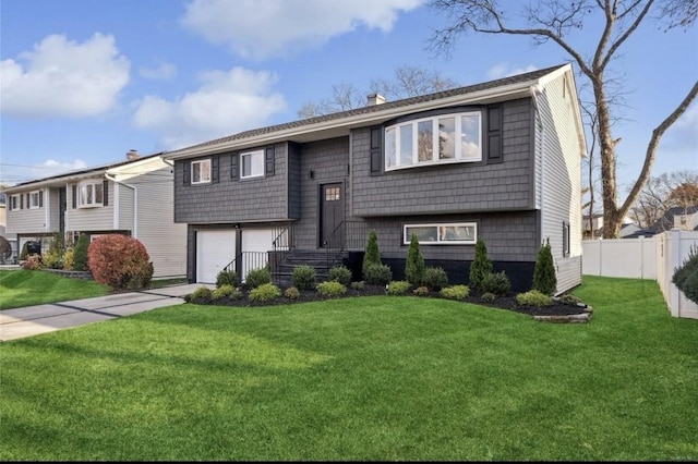 raised ranch featuring a chimney, a garage, and concrete driveway