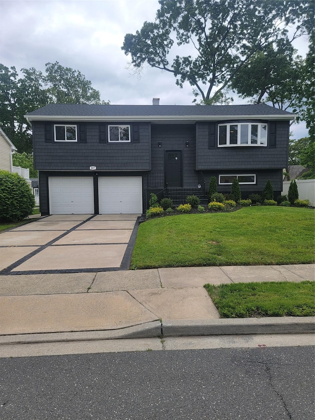 807 Iris Pl, West Hempstead, NY 11552 - bi-level home featuring an attached garage, a front lawn, and driveway