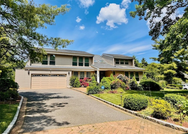 9 Hill And Tree Ct, Melville, NY 11747 - view of front of property featuring driveway, an attached garage, and a front lawn