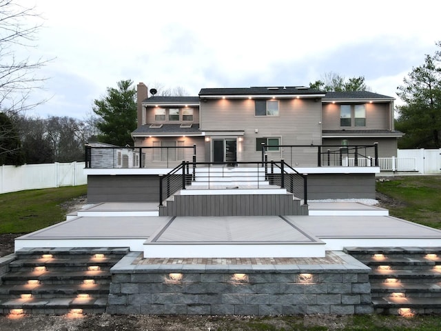 9 Hill And Tree Ct, Melville, NY 11747 - rear view of property featuring a deck, a chimney, and stairs