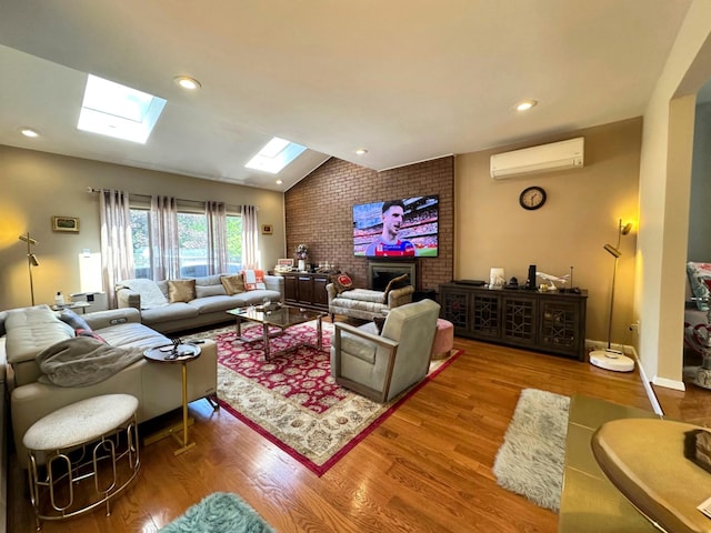 9 Hill And Tree Ct, Melville, NY 11747 - living room featuring a wall unit AC, a skylight, wood finished floors, vaulted ceiling, and a fireplace