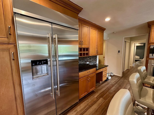 9 Hill And Tree Ct, Melville, NY 11747 - kitchen featuring appliances with stainless steel finishes, backsplash, dark wood-type flooring, dark countertops, and recessed lighting