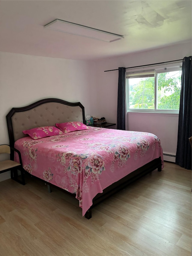 109 Convent Rd, Syosset, NY 11791 - bedroom featuring attic access, baseboard heating, and light wood-style floors