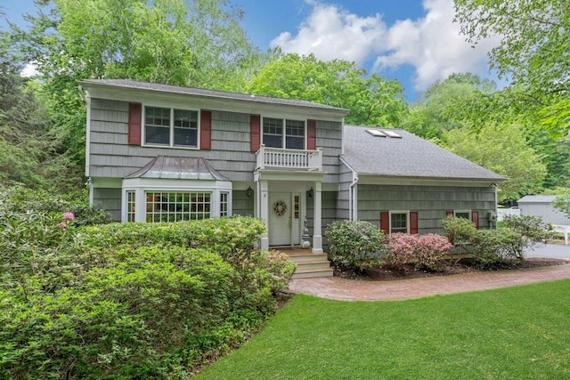 51 Hidden Hollow Ln, Millwood, NY 10546 - view of front of property with a shingled roof, a front lawn, and a balcony