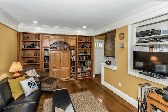 living area with ornamental molding, dark wood-style flooring, and baseboards
