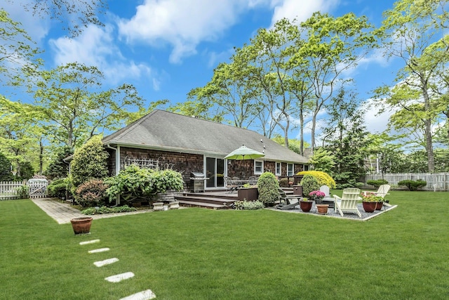rear view of property with a wooden deck and a shingled roof