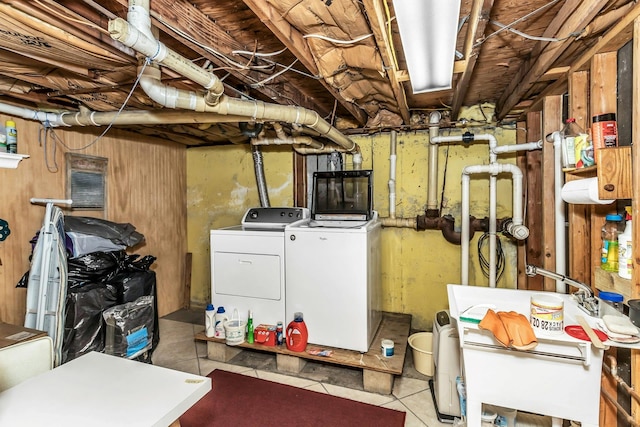 unfinished below grade area featuring separate washer and dryer and tile patterned flooring