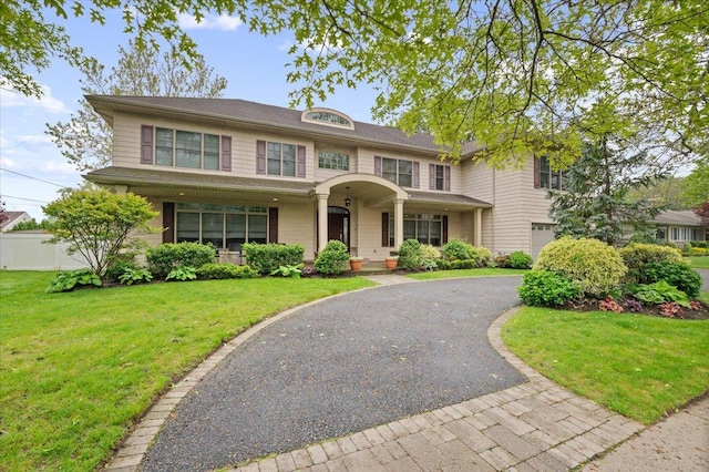 525 Green Pl, Woodmere, NY 11598 - view of front of house with covered porch, driveway, and an attached garage