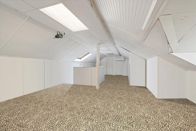 525 Green Pl, Woodmere, NY 11598 - bonus room featuring lofted ceiling, carpet, and wooden walls