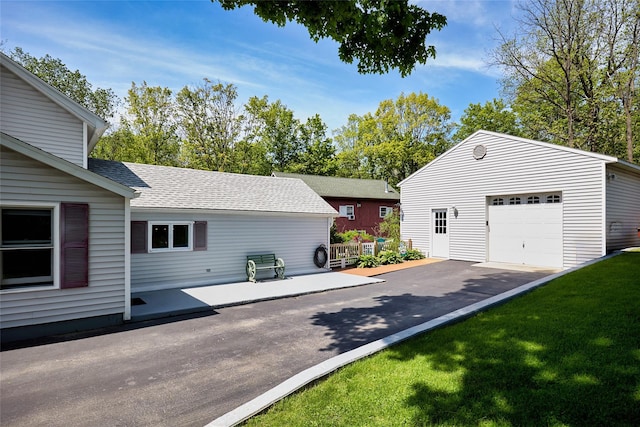 3 Rock Pl, Stanfordville, NY 12581 - view of home's exterior featuring a shingled roof, an outdoor structure, asphalt driveway, a yard, and a garage