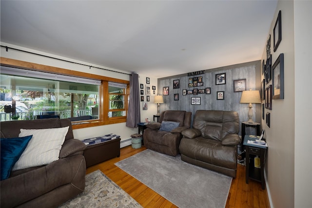 3 Rock Pl, Stanfordville, NY 12581 - living room with wood finished floors, a baseboard heating unit, and an accent wall