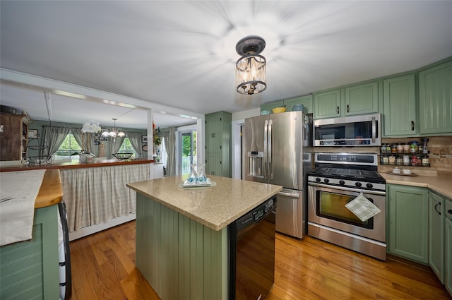 3 Rock Pl, Stanfordville, NY 12581 - kitchen with green cabinets, appliances with stainless steel finishes, wood finished floors, a chandelier, and a kitchen island