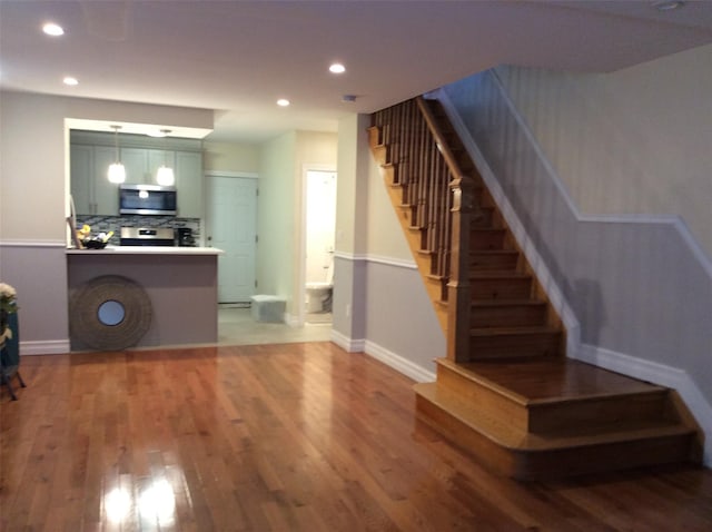 114-30 158th St, Jamaica, NY 11434 - living room featuring stairs, wood finished floors, recessed lighting, and baseboards