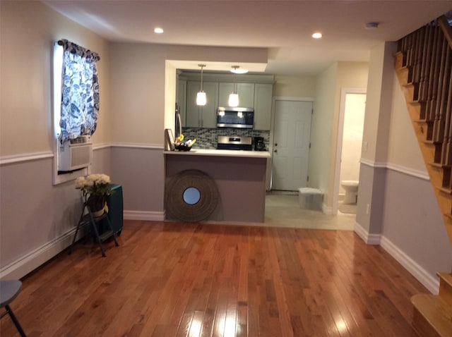 114-30 158th St, Jamaica, NY 11434 - kitchen featuring stainless steel microwave, range, wood-type flooring, green cabinetry, and recessed lighting