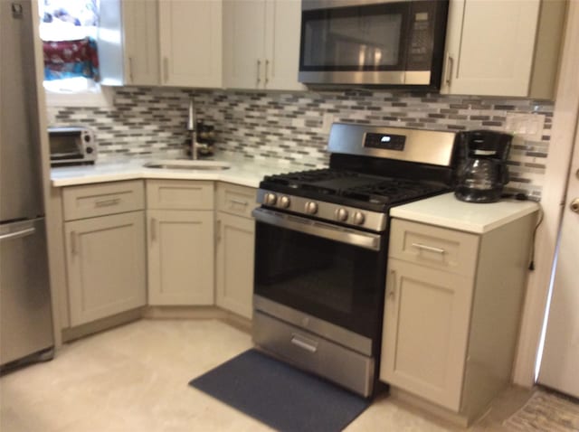 114-30 158th St, Jamaica, NY 11434 - kitchen with stainless steel appliances, a sink, light countertops, and tasteful backsplash