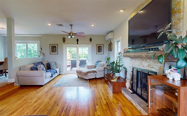 395 Toleman Rd, Washingtonville, NY 12575 - living room featuring healthy amount of natural light, a wall mounted air conditioner, a ceiling fan, a fireplace, and recessed lighting