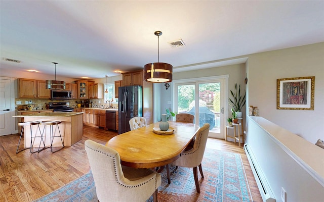 395 Toleman Rd, Washingtonville, NY 12575 - dining room with baseboard heating and light wood-style flooring