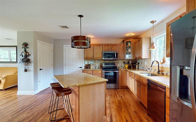 395 Toleman Rd, Washingtonville, NY 12575 - kitchen featuring stainless steel appliances, a sink, light wood-type flooring, tasteful backsplash, and plenty of natural light