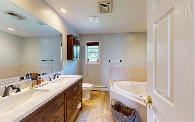 395 Toleman Rd, Washingtonville, NY 12575 - bathroom with baseboard heating, double vanity, a whirlpool tub, toilet, and recessed lighting