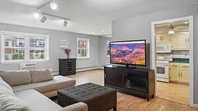 109 Doxbury Ln, Suffern, NY 10901 - living room with a wall unit AC, light wood-style floors, baseboard heating, ceiling fan, and recessed lighting