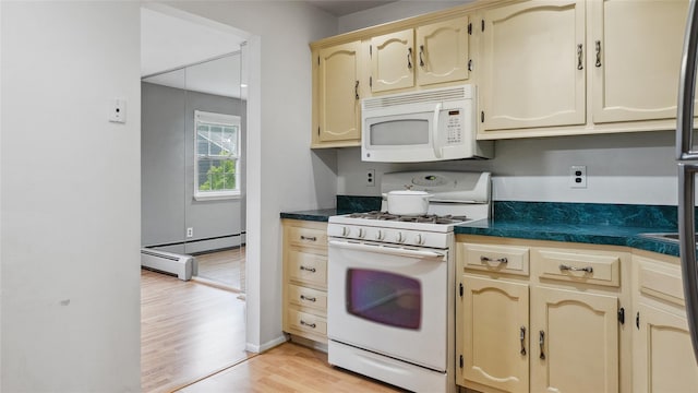 109 Doxbury Ln, Suffern, NY 10901 - kitchen with white appliances, light wood-style flooring, dark countertops, baseboard heating, and cream cabinets