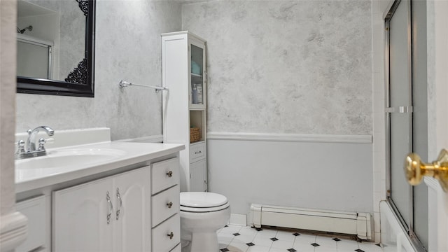 109 Doxbury Ln, Suffern, NY 10901 - full bath with a baseboard heating unit, toilet, tile patterned floors, vanity, and enclosed tub / shower combo