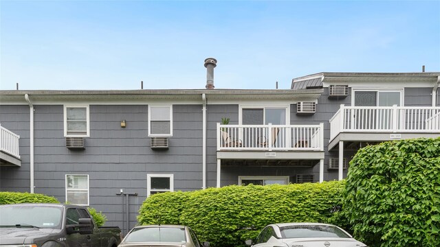 109 Doxbury Ln, Suffern, NY 10901 - back of property featuring a balcony and an AC wall unit