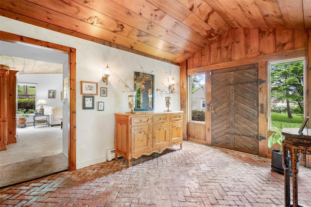 66 Susan Dr, Newburgh, NY 12550 - foyer with baseboard heating, wooden walls, vaulted ceiling, brick flooring, and wood ceiling