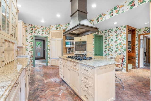 66 Susan Dr, Newburgh, NY 12550 - kitchen featuring wallpapered walls, island exhaust hood, brick floors, light stone countertops, and recessed lighting