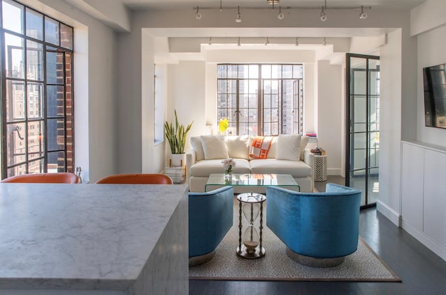 living area featuring dark wood-style floors and baseboards