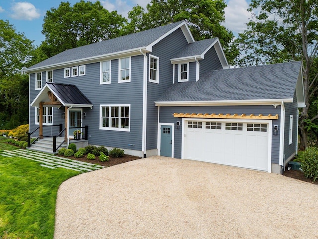 480 Ackerly Pond Ln, Southold, NY 11971 - colonial home featuring concrete driveway, an attached garage, a front lawn, and a shingled roof