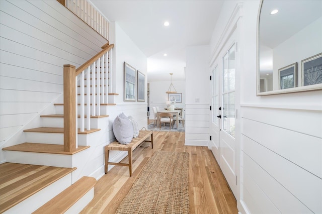 480 Ackerly Pond Ln, Southold, NY 11971 - corridor featuring stairway, wood finished floors, recessed lighting, french doors, and wainscoting