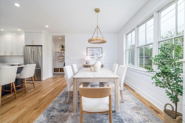 480 Ackerly Pond Ln, Southold, NY 11971 - dining area featuring light wood-style flooring, recessed lighting, and a wainscoted wall